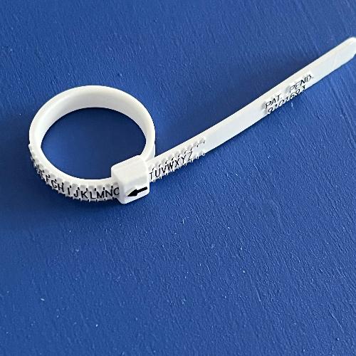 ring sizer on blue background