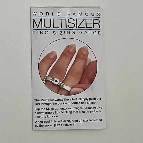 Ring sizer on white background in paper envelope