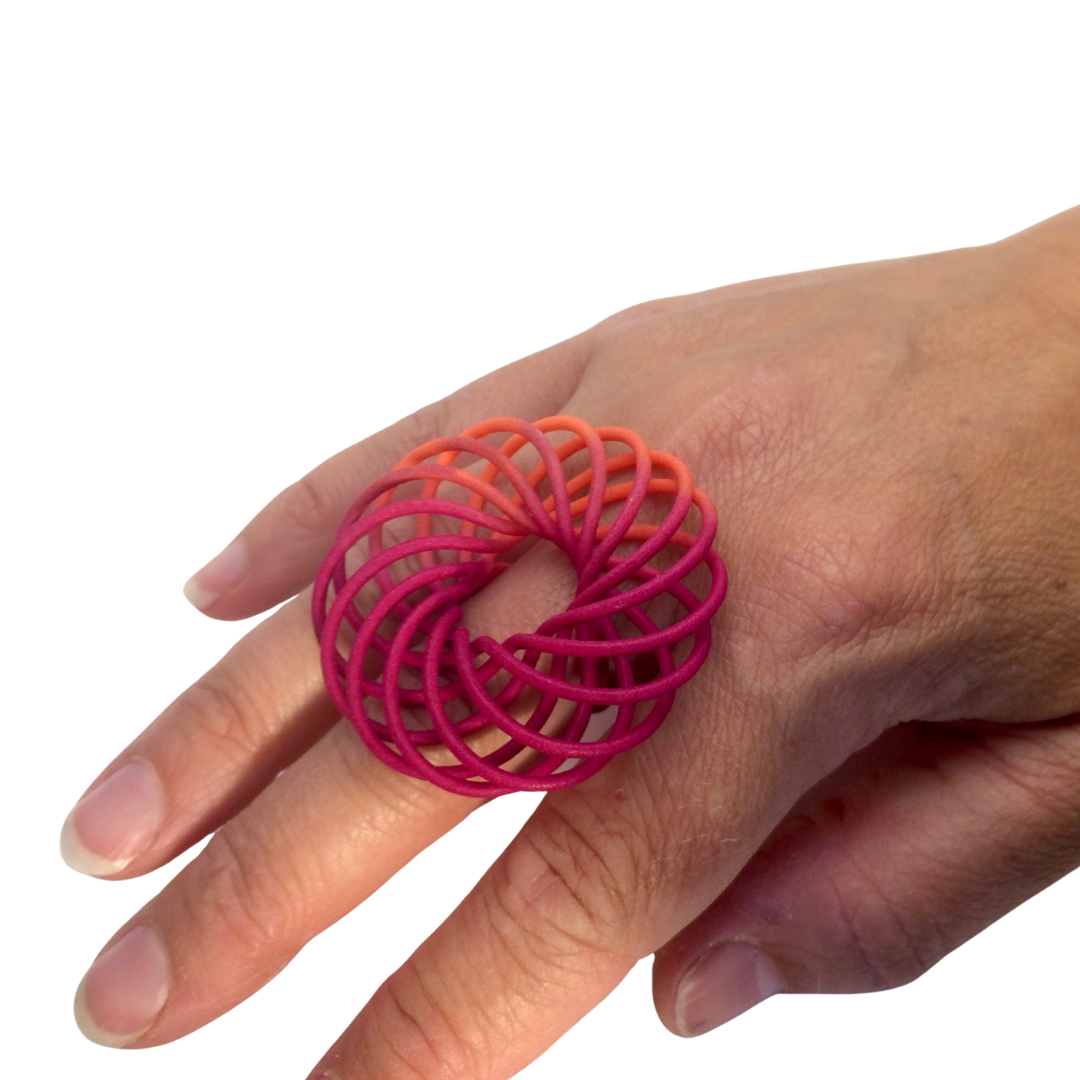 Bright pink peach ring on a hand