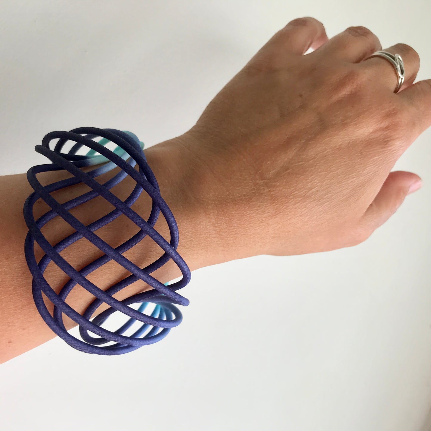 Turquoise Blue fade wide vortex bangle on model with loop ring