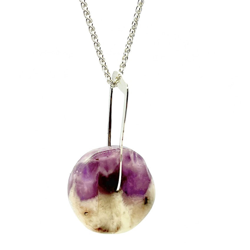 amethyst pendant hanging on sterling silver chain
