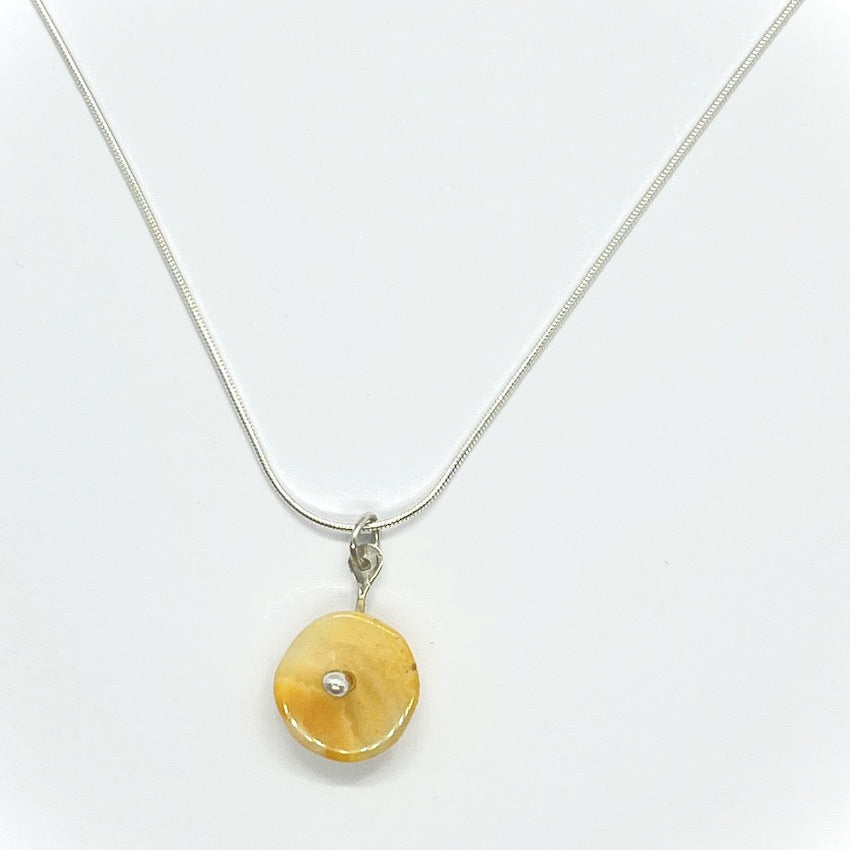 yellow agate pendant on a snake chain
