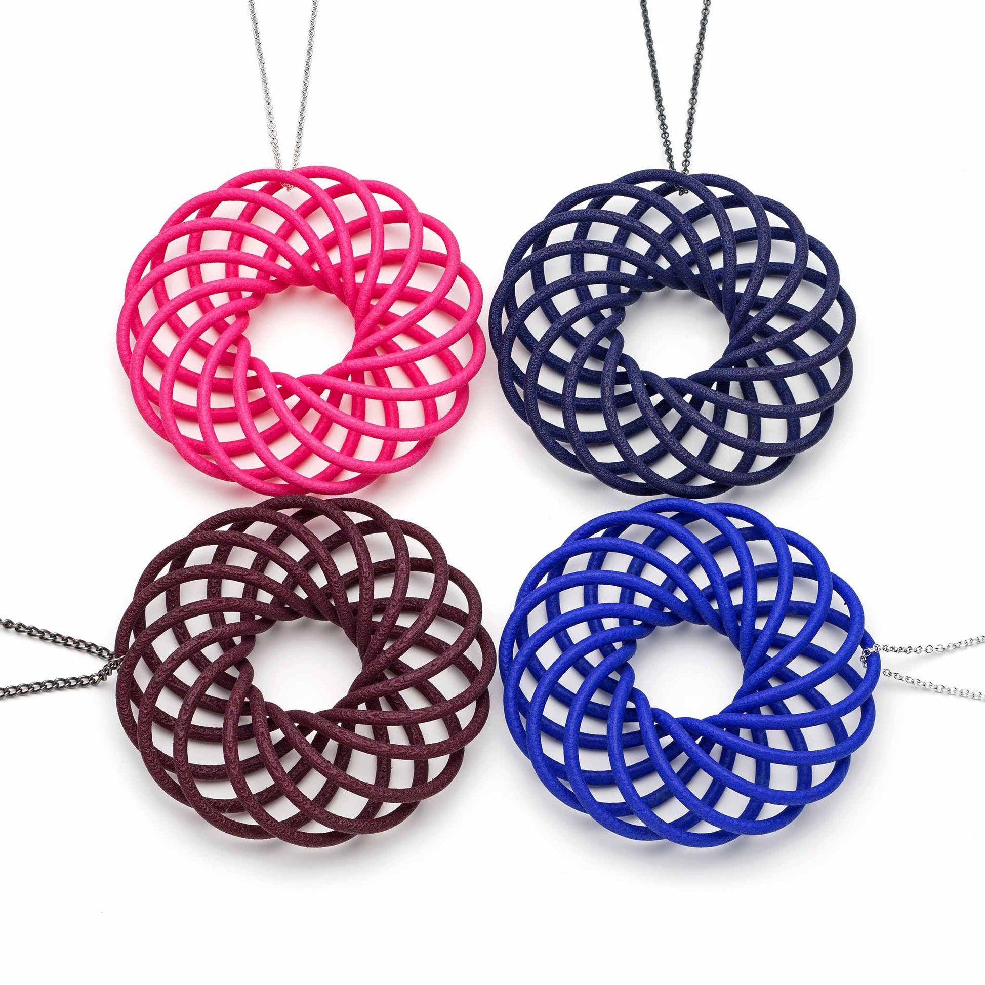 Four colourful Vortex 3D printed nylon pendants on silver chains by Katy Luxton Jewellery