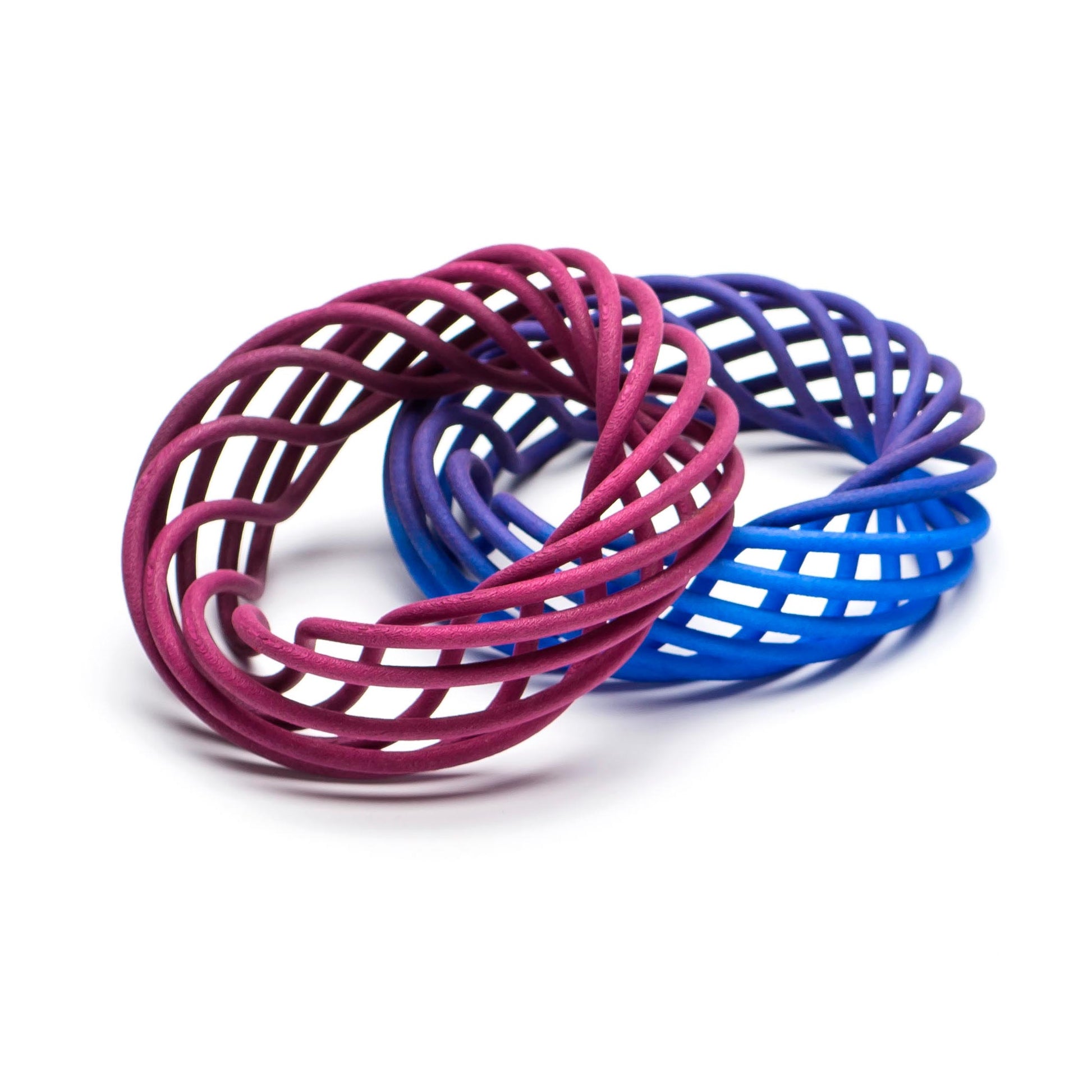 Vortex 3D printed nylon bangles in magenta against blue to purple fade