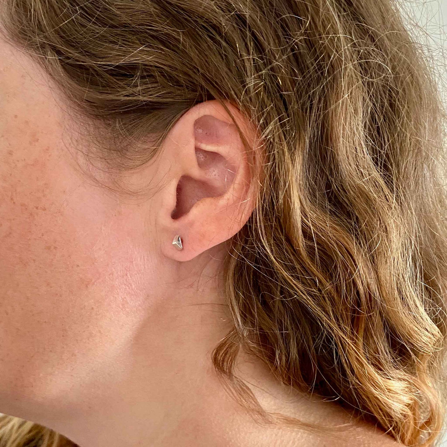 Katy wearing Triangle Tube Silver Stud earrings